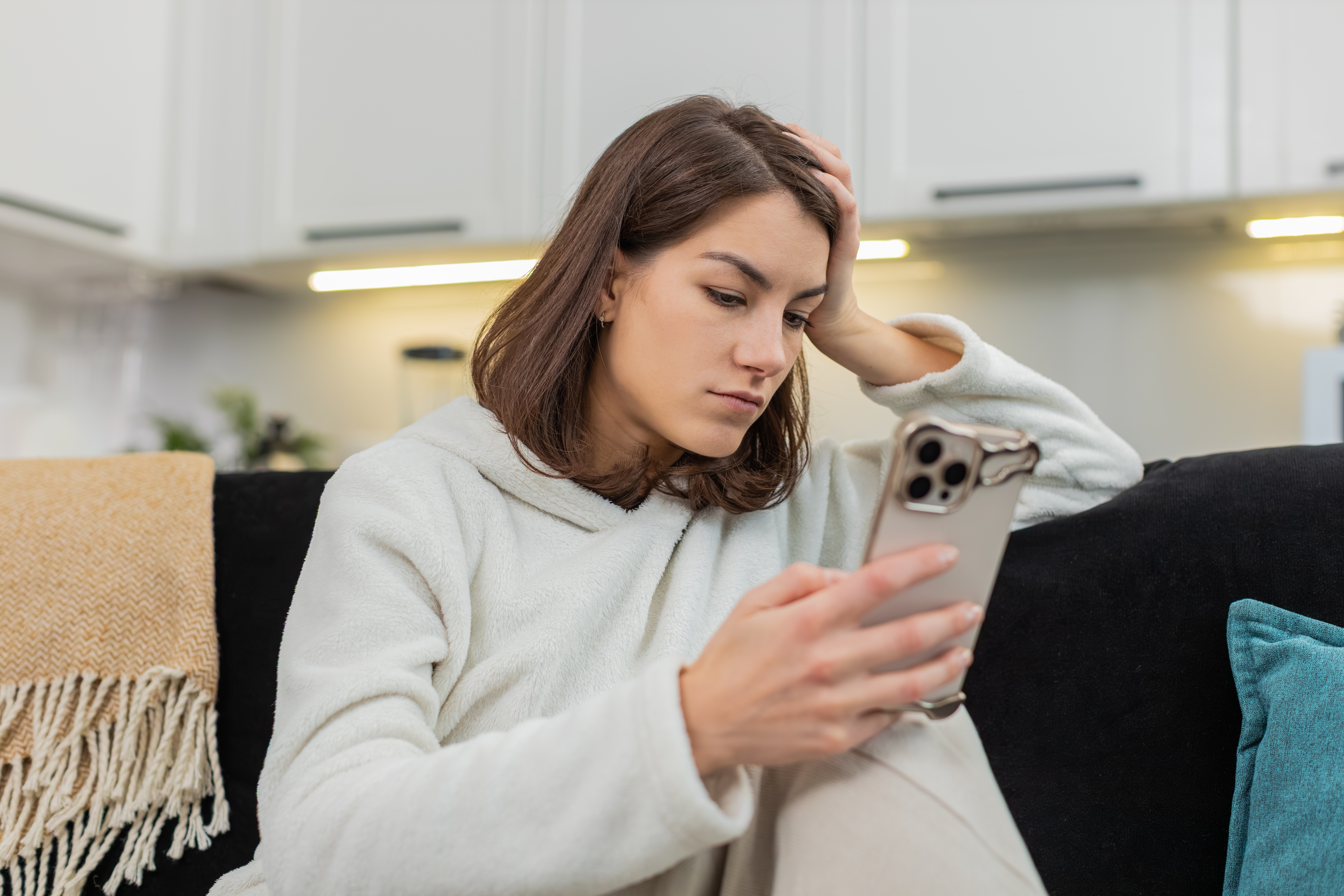 Woman on couch doomscrolling