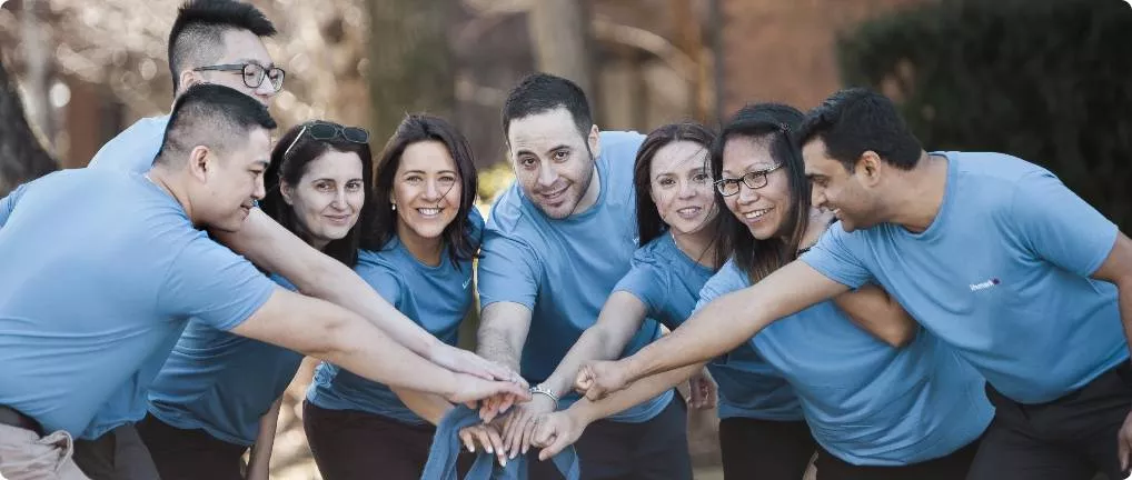 Team groupshot of the team with the hands in a pile